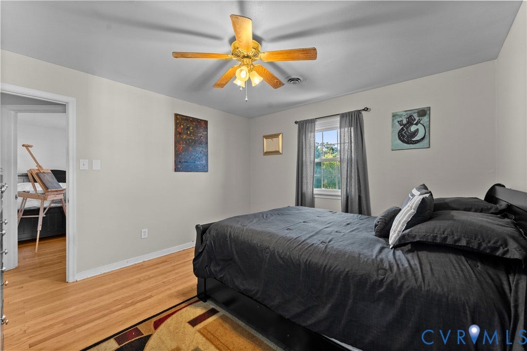 109 Webster Road, Sandston, VA 23150 Hardwood flooring, ceiling fan with integrated lighting, window with drapes, and neutral wall paint