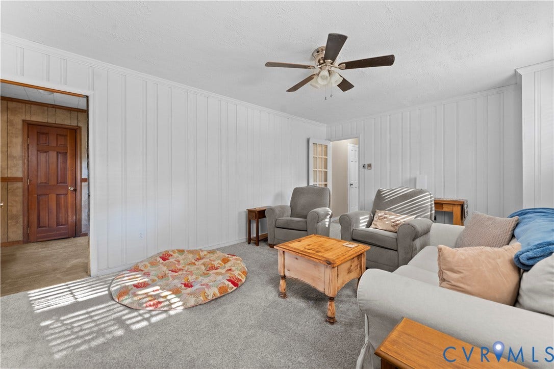 109 Webster Road, Sandston, VA 23150 Carpeted flooring, white paneled walls, ceiling fan with light fixture, and wood-panel door