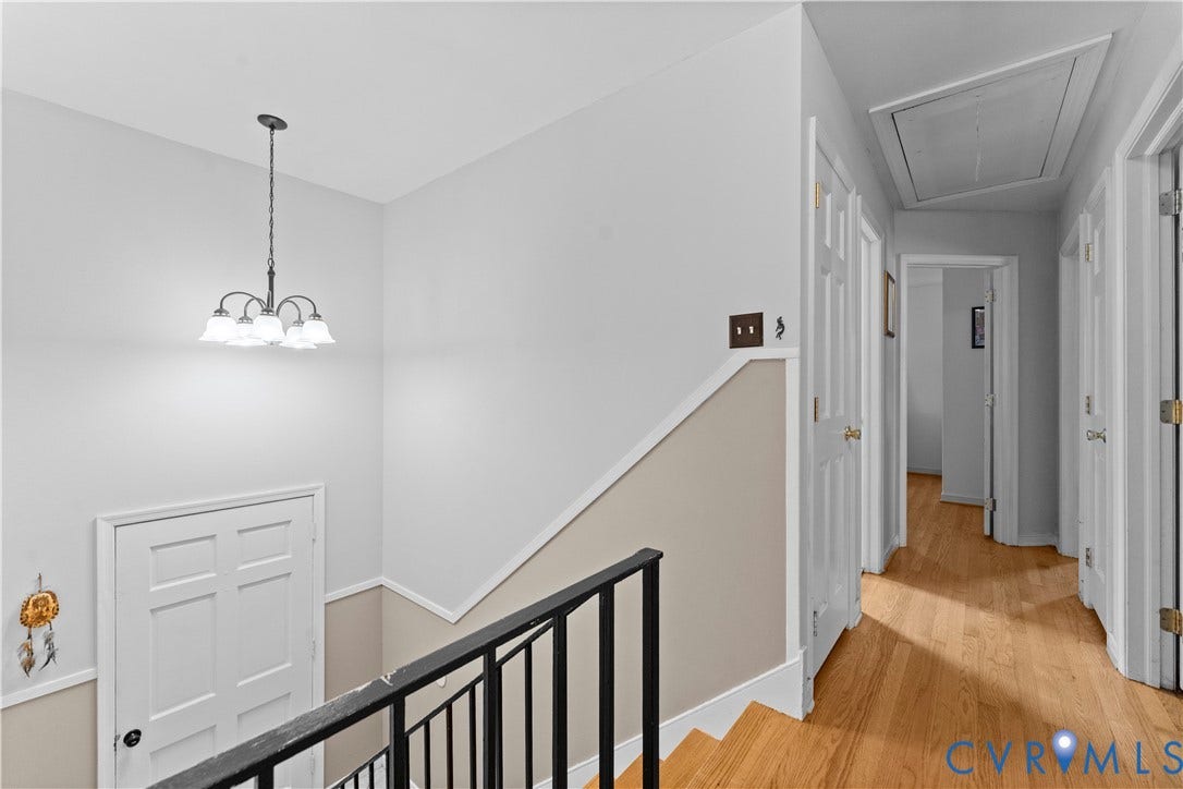 109 Webster Road, Sandston, VA 23150 Hardwood flooring, painted interior doors, chandelier lighting, painted walls, and dark metal railing