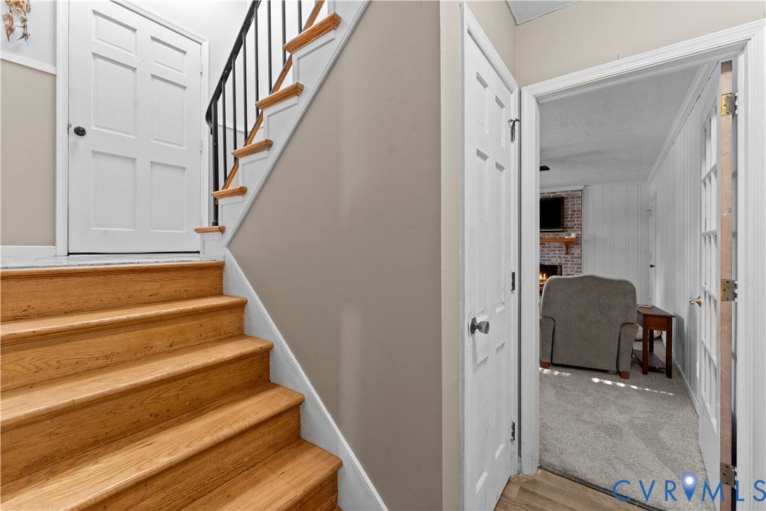 109 Webster Road, Sandston, VA 23150 Wood-finish stairs with white risers and a black metal handrail