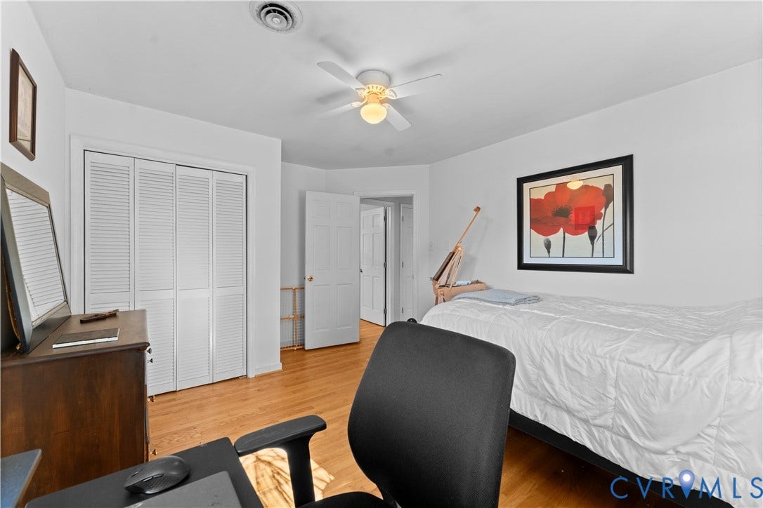 109 Webster Road, Sandston, VA 23150 Hardwood flooring, white walls, louvered bi-fold closet doors, ceiling fan with integrated lighting, and white interior doors