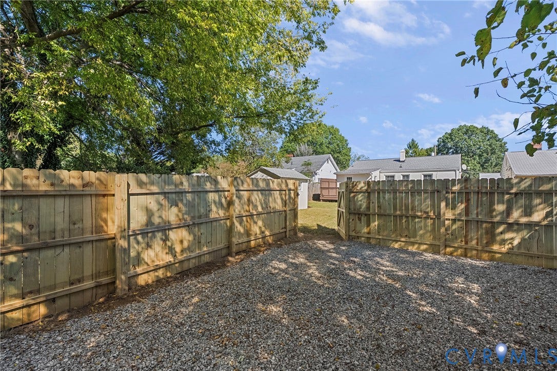 5304 Gillespie Avenue, Henrico, VA 23228 Gravel surface area with a wood privacy fence and a gated entry