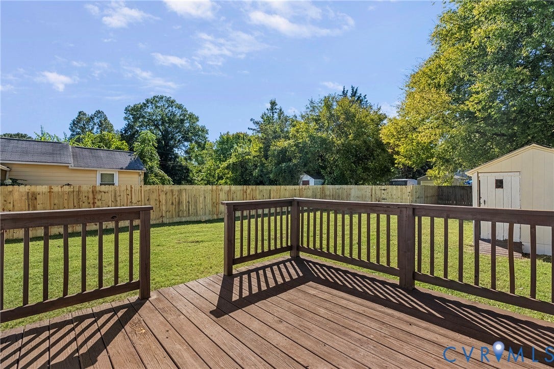 5304 Gillespie Avenue, Henrico, VA 23228 Wood deck with dark wood railing, overlooking a fenced backyard with green lawn