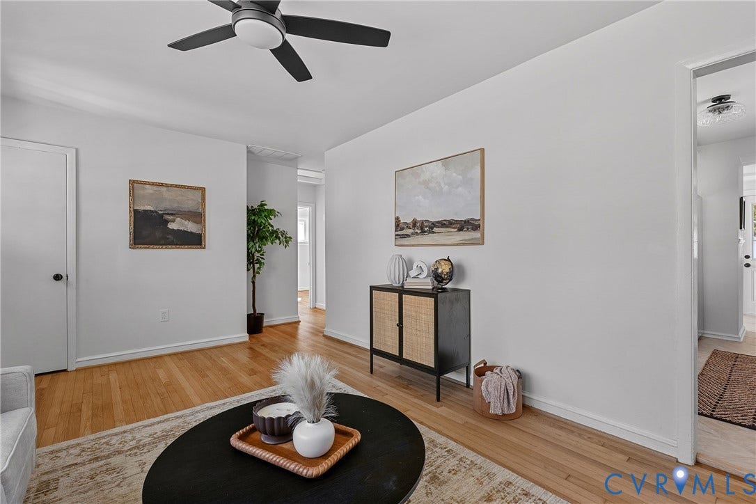 5304 Gillespie Avenue, Henrico, VA 23228 Hardwood flooring, painted walls, modern ceiling fan, white trim, and a doorway with a black knob
