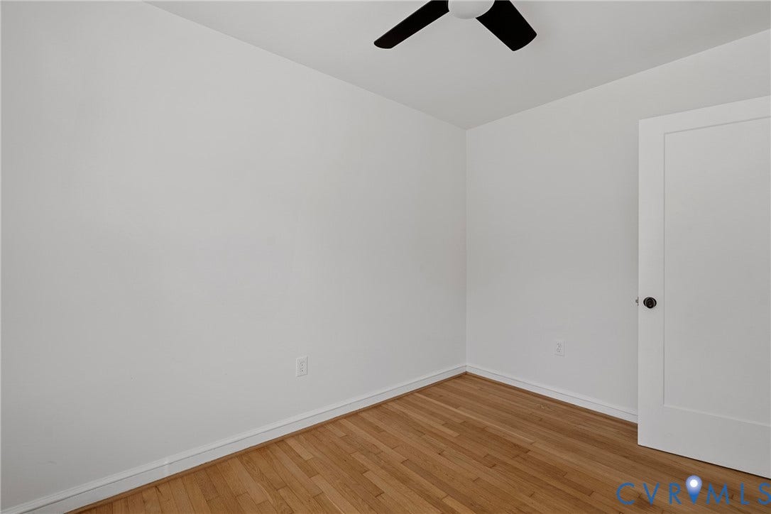 5304 Gillespie Avenue, Henrico, VA 23228 Wood-finish flooring, white painted walls, and a modern ceiling fan with black blades