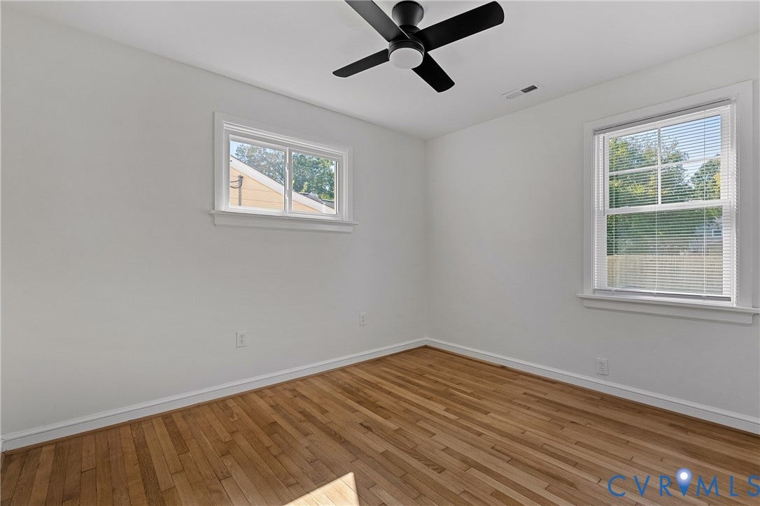 5304 Gillespie Avenue, Henrico, VA 23228 Wood-finish flooring, white walls, two windows, and a black ceiling fan