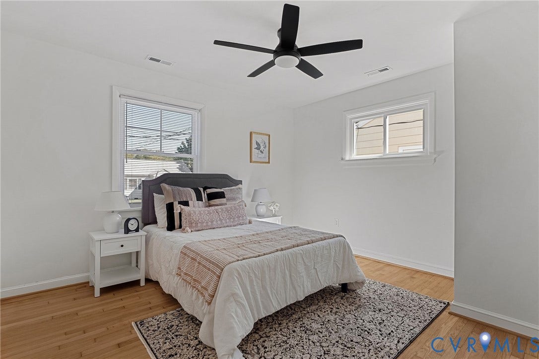 5304 Gillespie Avenue, Henrico, VA 23228 Light wood flooring, white painted walls, white trim, two windows, and a ceiling fan with integrated lighting