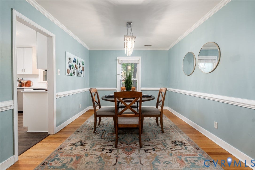 Hardwood flooring, crown molding, chair rail molding, and a built-in chandelier.