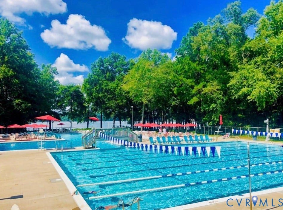 Expansive multi-pool aquatic area featuring a lap pool, a recreational pool, and a children's pool