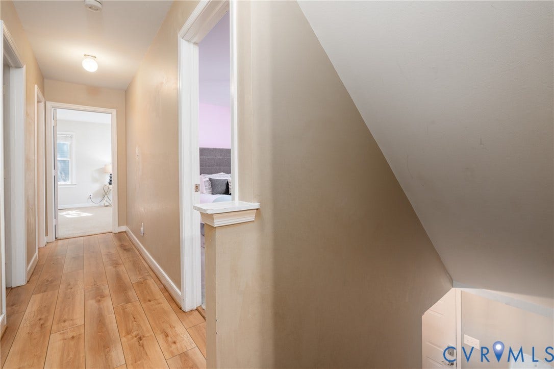 Wood-finish flooring throughout the hallway.