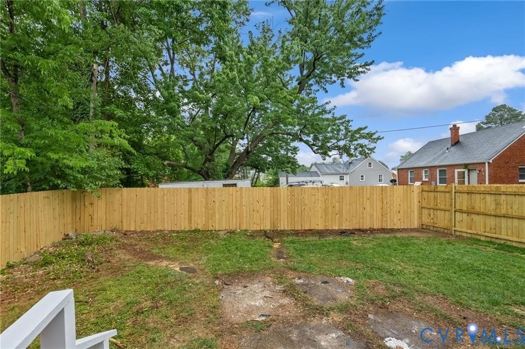 Expansive backyard with a new wood privacy fence