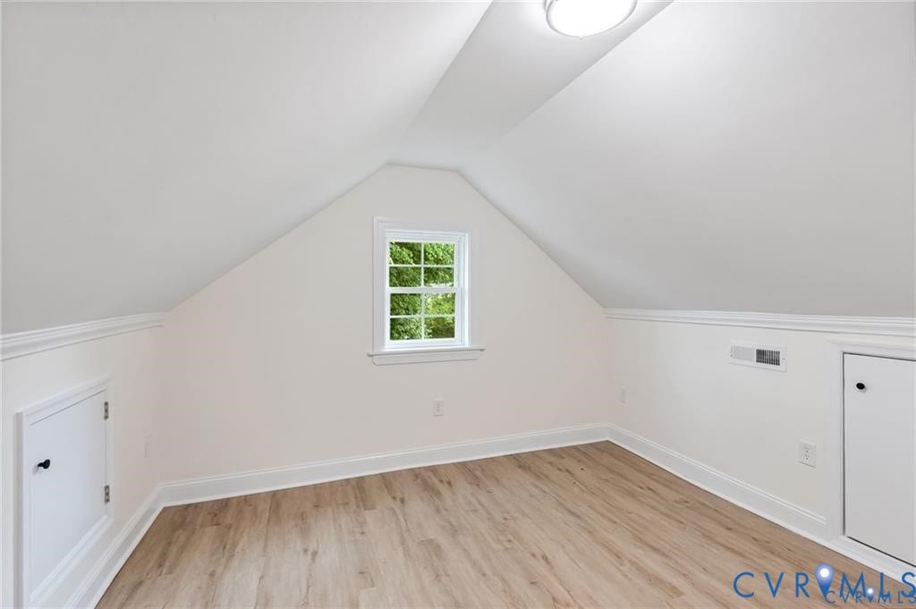 Sloping ceilings, wood-finish flooring, and a single-pane window