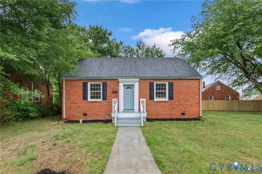 Brick exterior with a dark shingle roof
