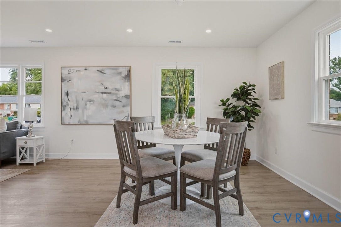 Recessed lighting, wood-finish flooring, white trim, and multiple windows