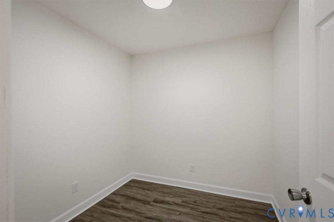 Recessed ceiling light, wood-finish flooring, white wall paint, white trim, white paneled door