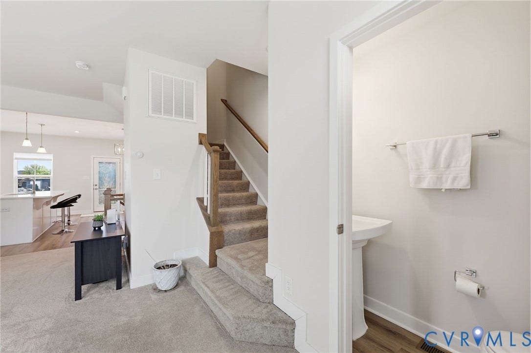 Stairs to third level and half bath.