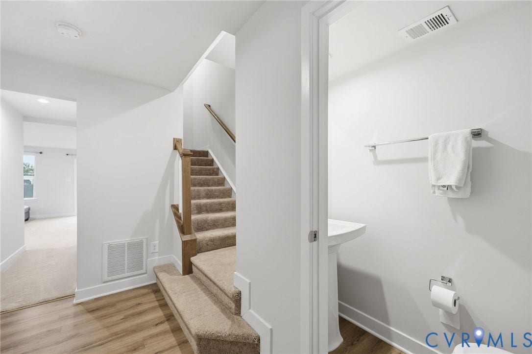 Half bath and stairs to second level.