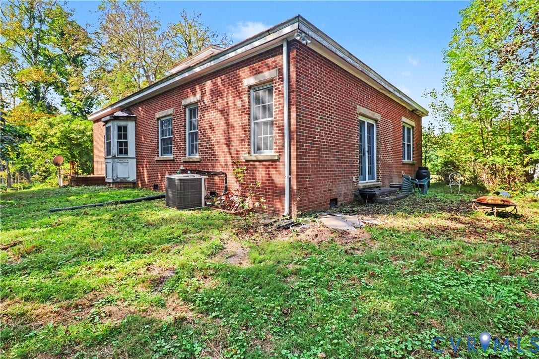 Brick exterior with multiple windows and a bay window element