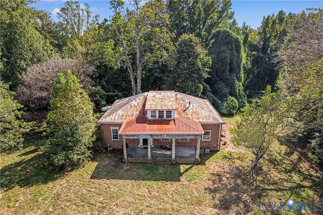 Brick exterior with a covered porch featuring support columns