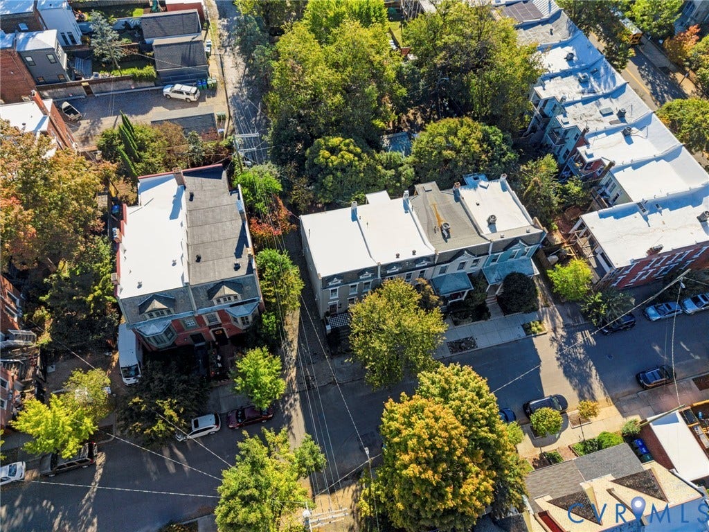 107 N Allen Avenue, The Fan, Richmond, VA 23220 Aerial perspective featuring brick row houses with flat roofing, dormer windows, and mature tree canopy throughout the streetscape