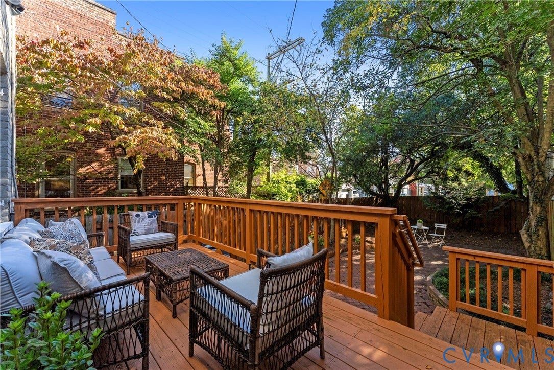 107 N Allen Avenue, The Fan, Richmond, VA 23220 Multi-level wood deck featuring built-in railings, steps, and mature tree canopy overhead