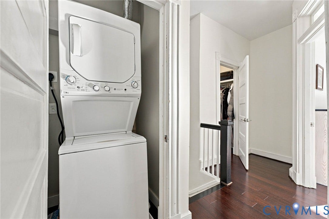 107 N Allen Avenue, The Fan, Richmond, VA 23220 Stacked laundry center featuring a white finish, dark wood-finish flooring, and multi-panel interior doors