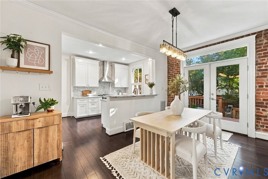 107 N Allen Avenue, The Fan, Richmond, VA 23220 Kitchen and dining area featuring white shaker-style cabinetry, mosaic tile backsplash, wood-finish flooring, exposed brick wall, and glass-paneled double doors