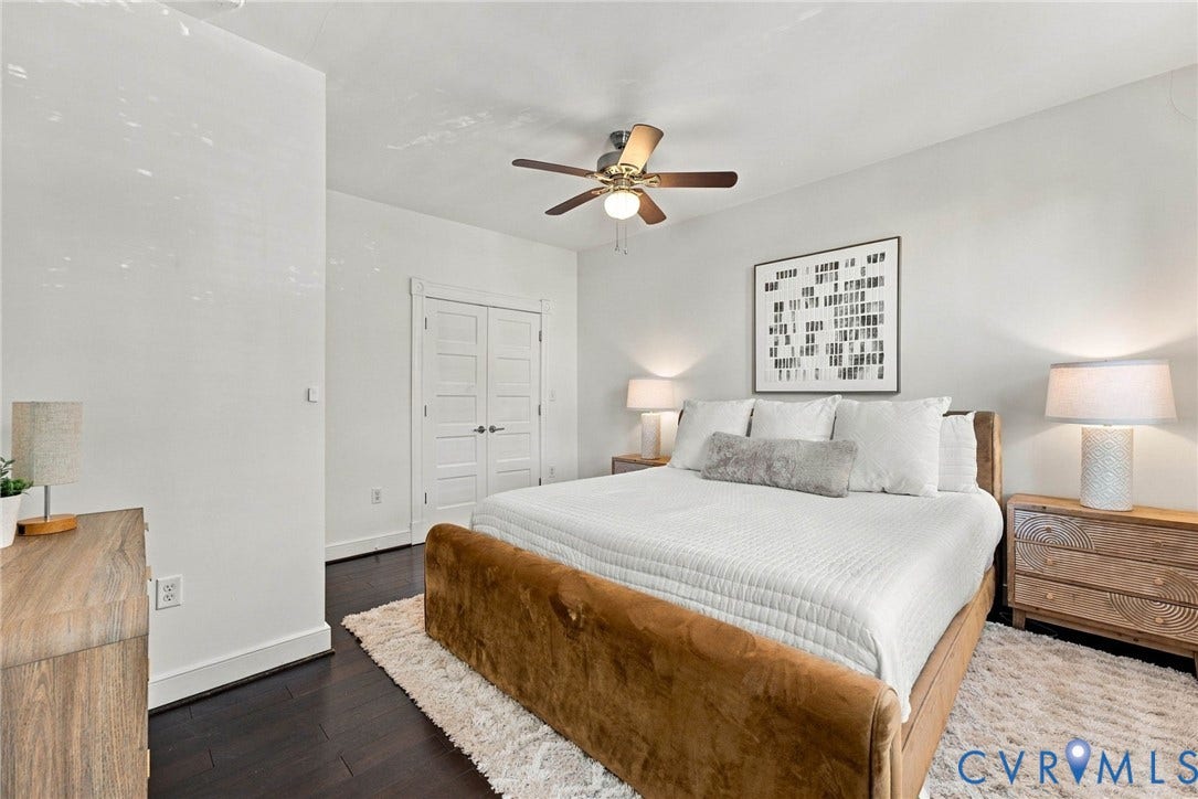 107 N Allen Avenue, The Fan, Richmond, VA 23220 Dark-toned wood-finish flooring, white five-panel double doors, and a central ceiling fan with integrated lighting