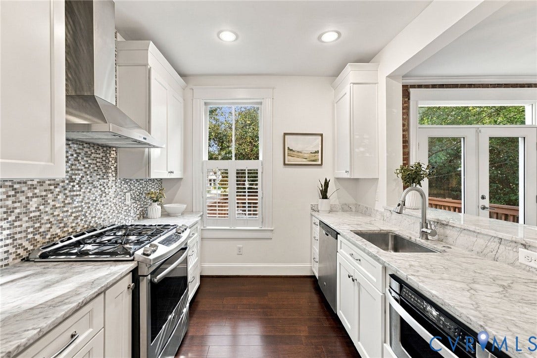 107 N Allen Avenue, The Fan, Richmond, VA 23220 Kitchen featuring stone countertops, stainless steel appliances, a mosaic tile backsplash, custom white cabinetry, and wood-finish flooring