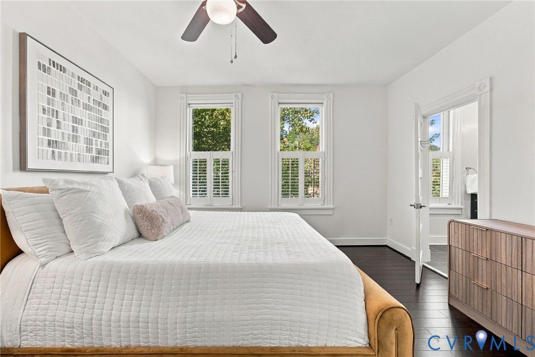 107 N Allen Avenue, The Fan, Richmond, VA 23220 Bedroom featuring dark wood-finish flooring, two windows with white plantation shutters, and a ceiling-mounted fan with integrated light fixture