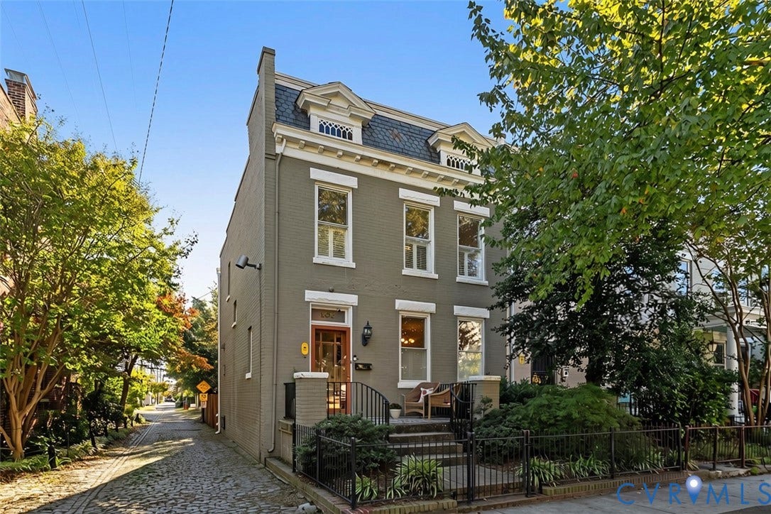 107 N Allen Avenue, The Fan, Richmond, VA 23220 Three-story brick exterior featuring a mansard roofline, dormer windows, decorative cornice detailing, and a front entry with wrought-iron railing