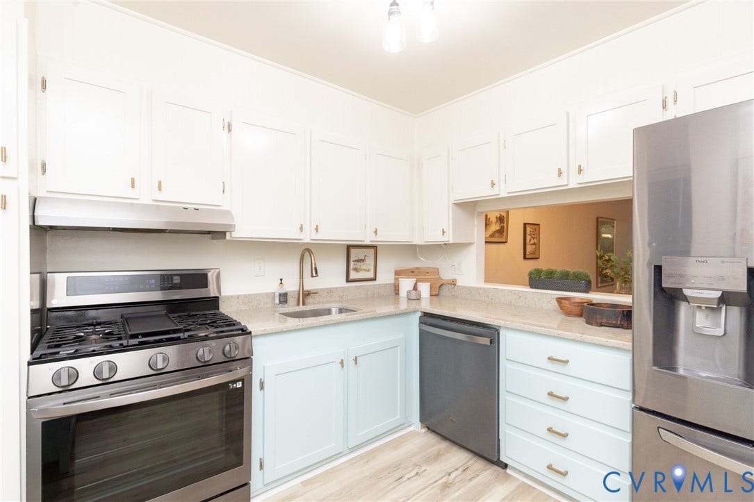 10404 Iron Mill Road, Chesterfield, VA 23235 Kitchen featuring light-colored cabinetry, stainless steel appliances, quartz countertops, and wood-finish flooring.