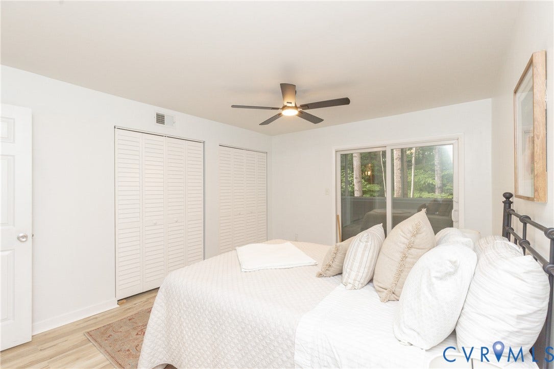 10404 Iron Mill Road, Chesterfield, VA 23235 Sliding glass door, wood-finish flooring, white walls, louvered closet doors, and ceiling fan with integrated lighting