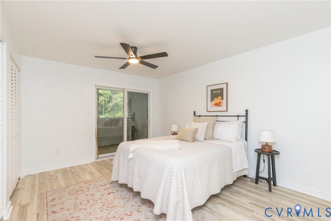 10404 Iron Mill Road, Chesterfield, VA 23235 Wood-finish flooring with a ceiling fan, sliding glass door, and louvered bifold closet doors.
