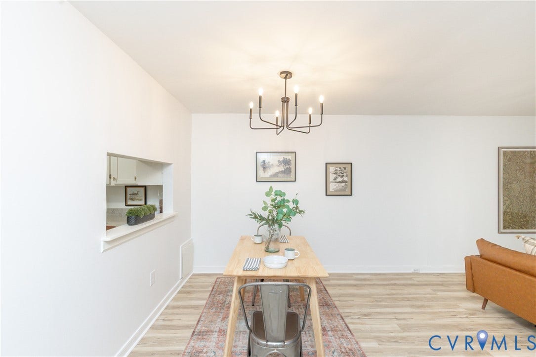 10404 Iron Mill Road, Chesterfield, VA 23235 Pass-through opening to the kitchen, wood-finish flooring, and a multi-arm chandelier.