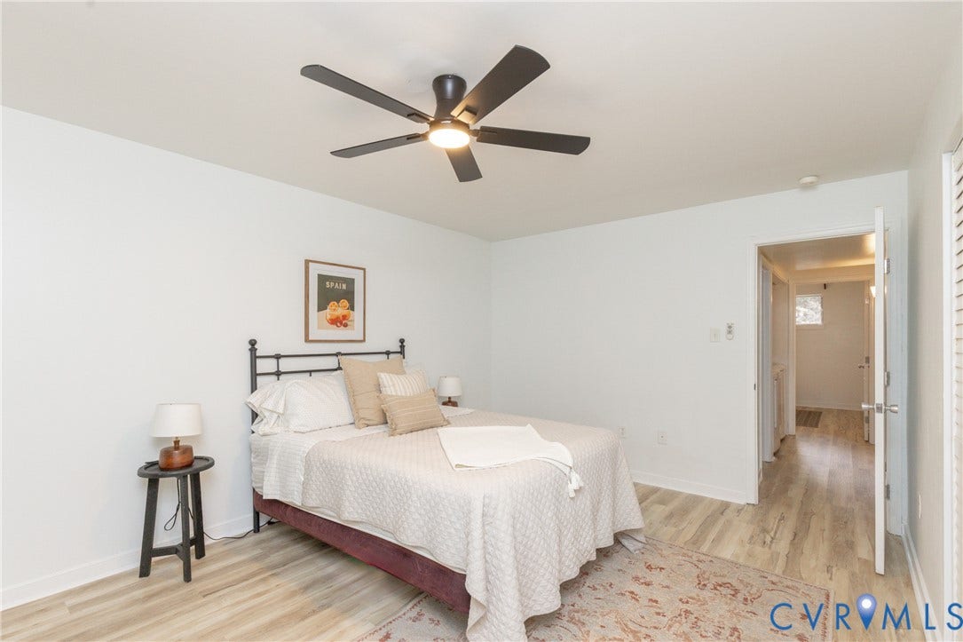 10404 Iron Mill Road, Chesterfield, VA 23235 ceiling fan light, wood-finish flooring, white walls, and a solid core door.