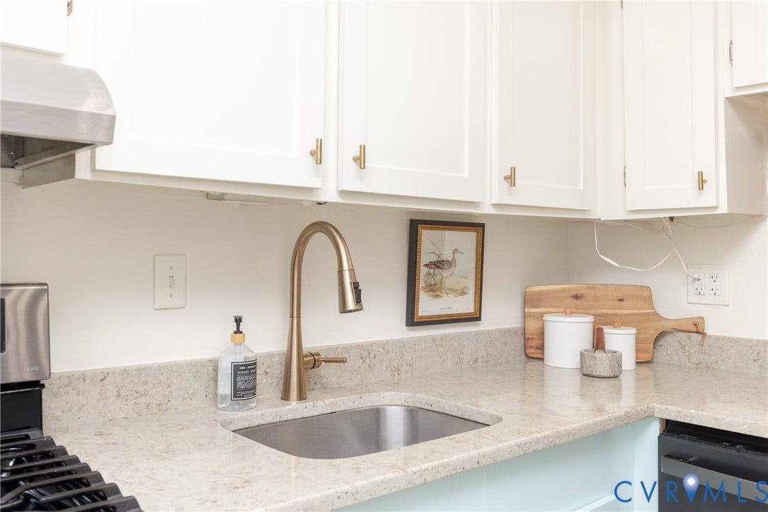 10404 Iron Mill Road, Chesterfield, VA 23235 White shaker cabinetry with gold-tone hardware, stainless steel sink, gold-tone pull-down faucet, and quartz countertops.