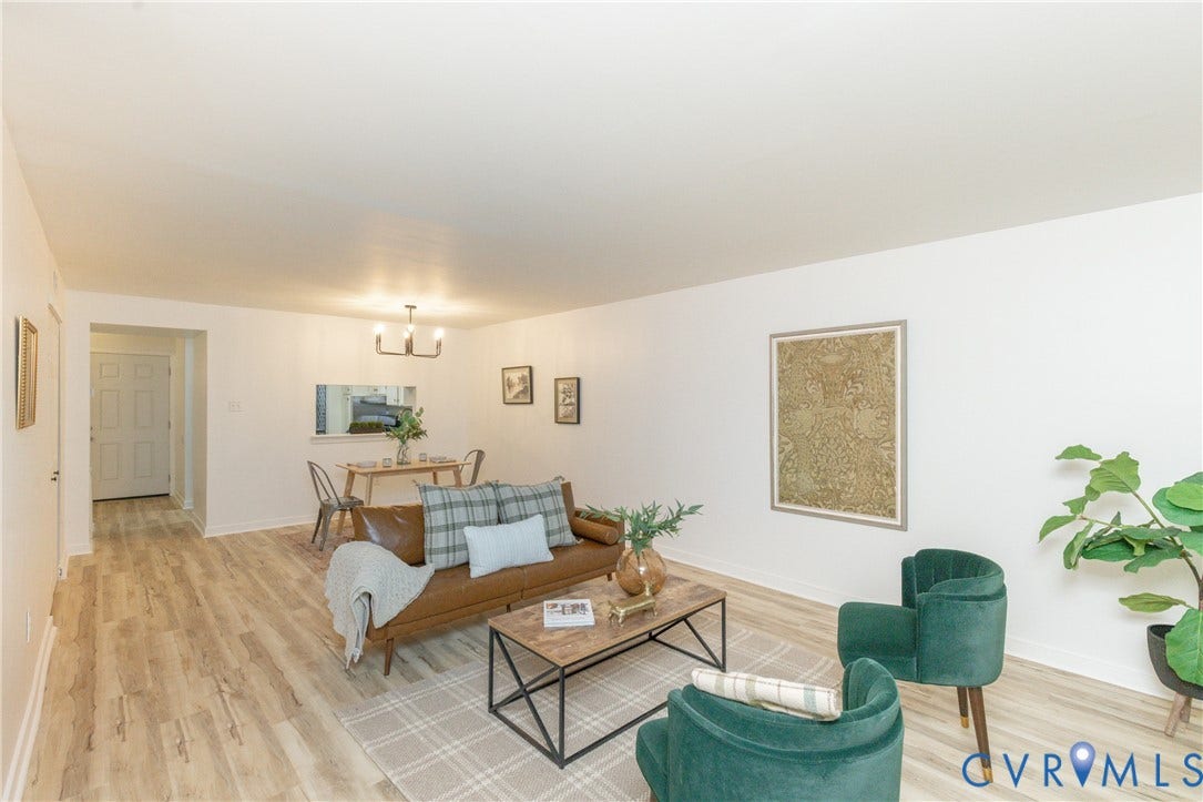 10404 Iron Mill Road, Chesterfield, VA 23235 Open-concept living space featuring wood-finish flooring, white walls, and a contemporary chandelier