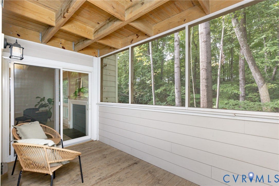 10404 Iron Mill Road, Chesterfield, VA 23235 Screened outdoor living area with wood-finish flooring, exposed wood beam ceiling, and a sliding glass door to living room