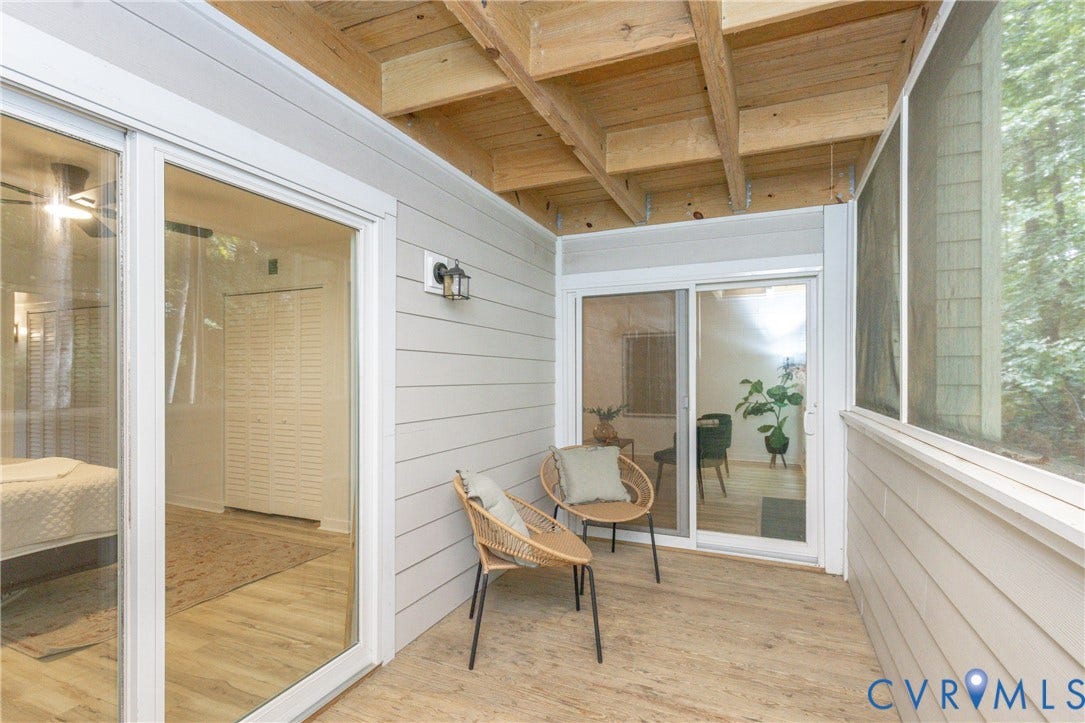10404 Iron Mill Road, Chesterfield, VA 23235 Screened-in porch with wood-finish flooring, exposed wood beam ceiling, and sliding glass doors to primary bedroom and living room.