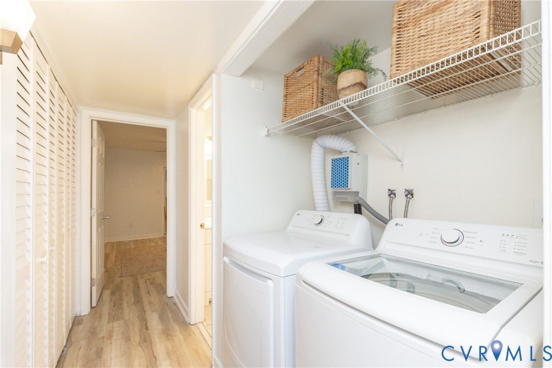 10404 Iron Mill Road, Chesterfield, VA 23235 Dedicated laundry area featuring white appliances, a wire shelving unit, and wood-finish flooring.