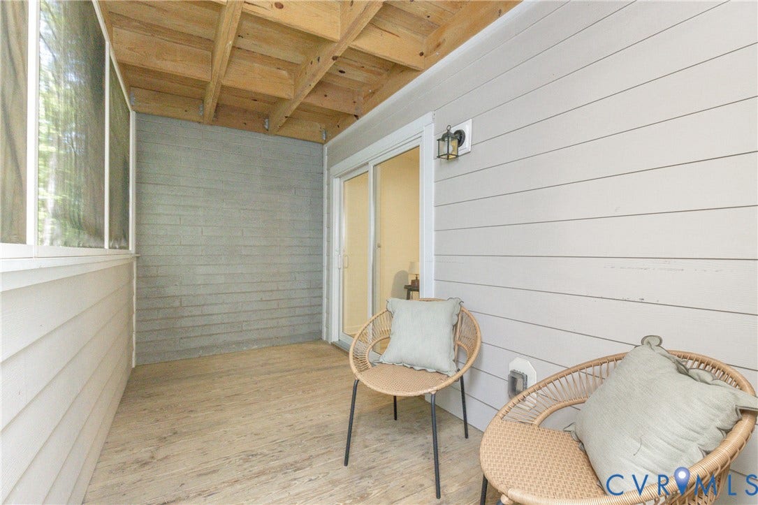 10404 Iron Mill Road, Chesterfield, VA 23235 Screened porch with wood-finish flooring, exposed wood beam ceiling, and a sliding glass door entry to primary bedroom.