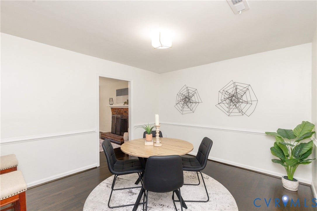 Recessed lighting, wood-finish flooring, white walls, chair rail molding, and a cased opening