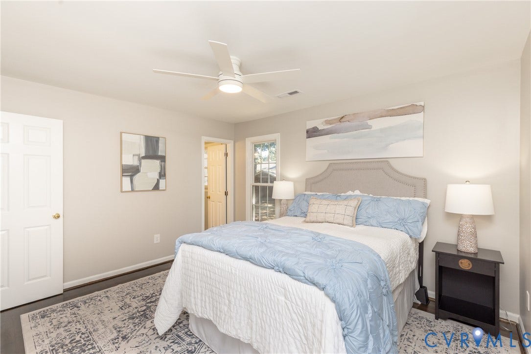 Recessed lighting, ceiling fan, dark wood-finish flooring, white paneled door, and a window with natural light