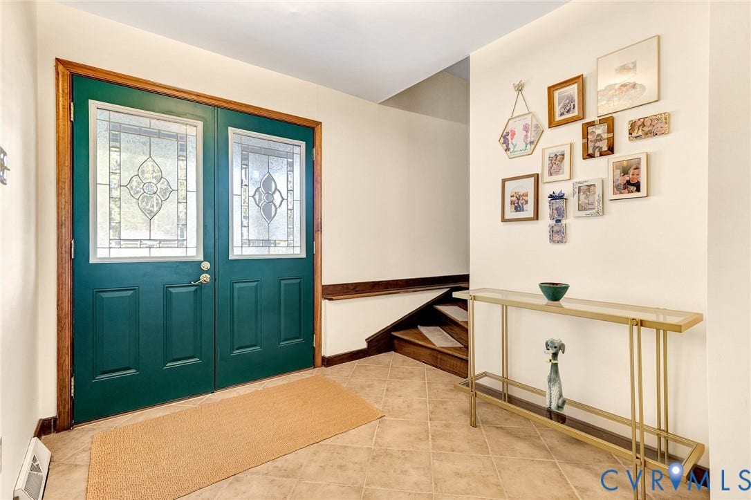 11410 Driscoll Road, Chester, VA 23831 Double front doors with decorative glass inserts, tile flooring, and wood stair accents