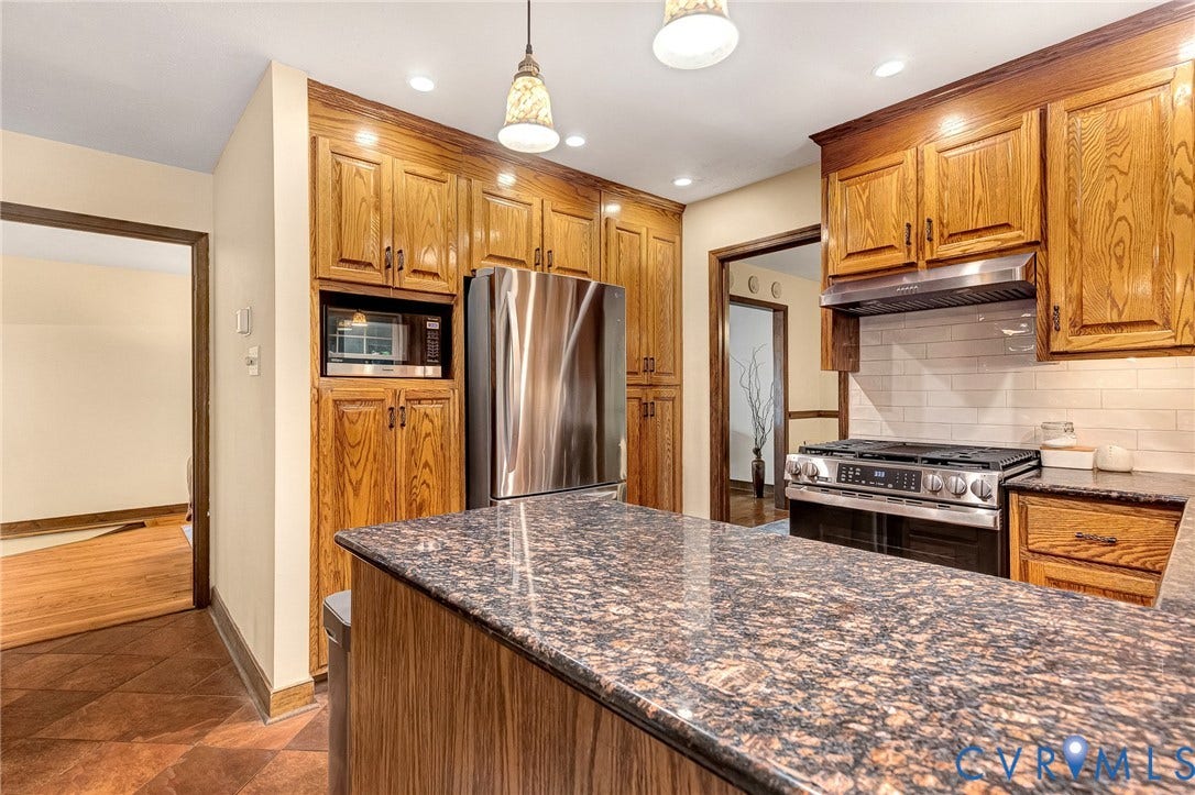 11410 Driscoll Road, Chester, VA 23831 Kitchen featuring wood cabinetry, stone countertops, stainless steel appliances, a white tile backsplash, and overhead pendant lighting