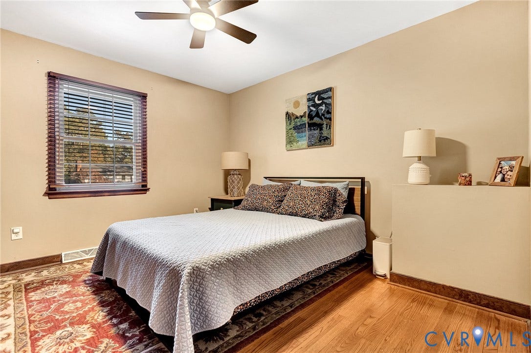 11410 Driscoll Road, Chester, VA 23831 Room featuring wood-finish flooring, a multi-pane window with blinds, and a ceiling fan with integrated lighting
