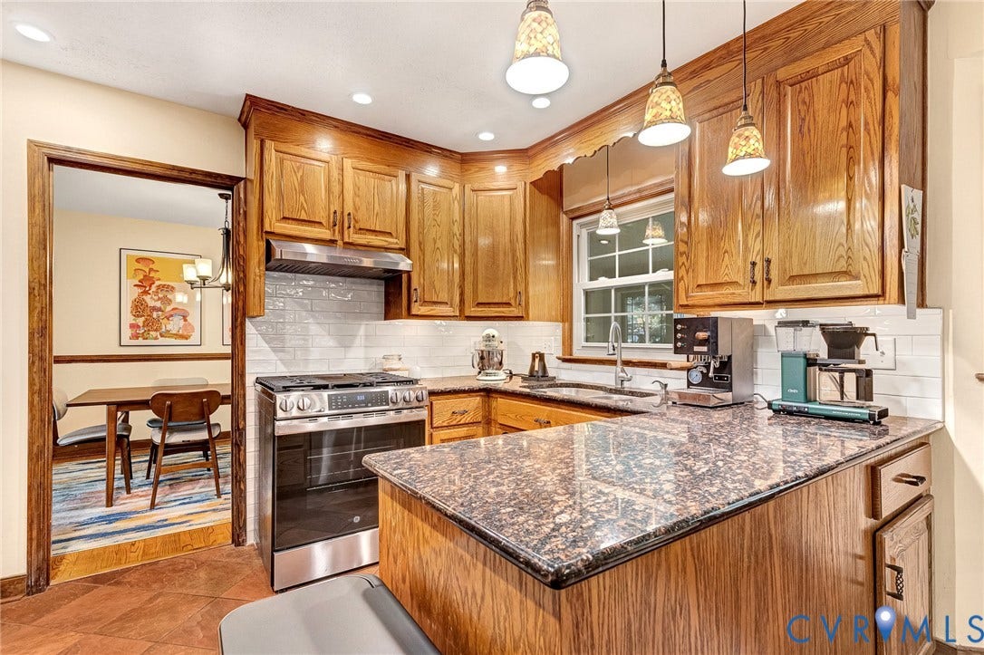 11410 Driscoll Road, Chester, VA 23831 Kitchen featuring wood cabinetry, stone countertops, subway tile backsplash, stainless steel range with overhead hood, and three pendant lights