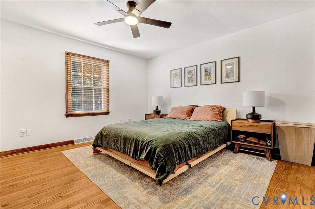 11410 Driscoll Road, Chester, VA 23831 Wood-finish flooring, multi-pane window with wood-trim framing, and a ceiling-mounted light fixture with integrated fan