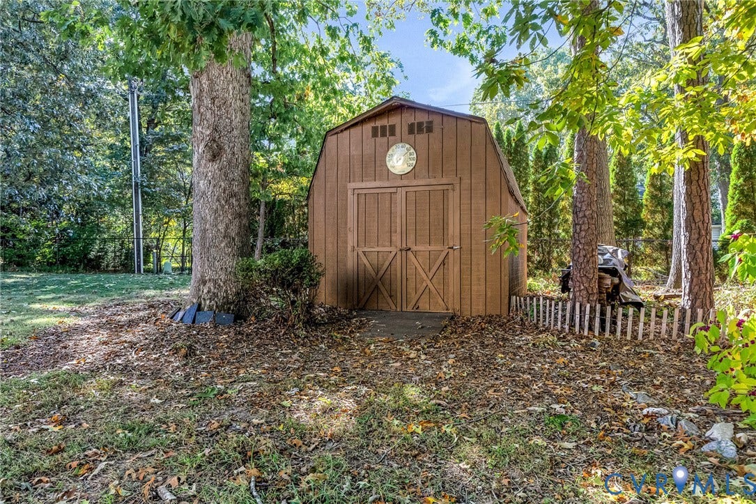 11410 Driscoll Road, Chester, VA 23831 Storage structure featuring a gambrel roof design, double-door entry, and wood-finish siding